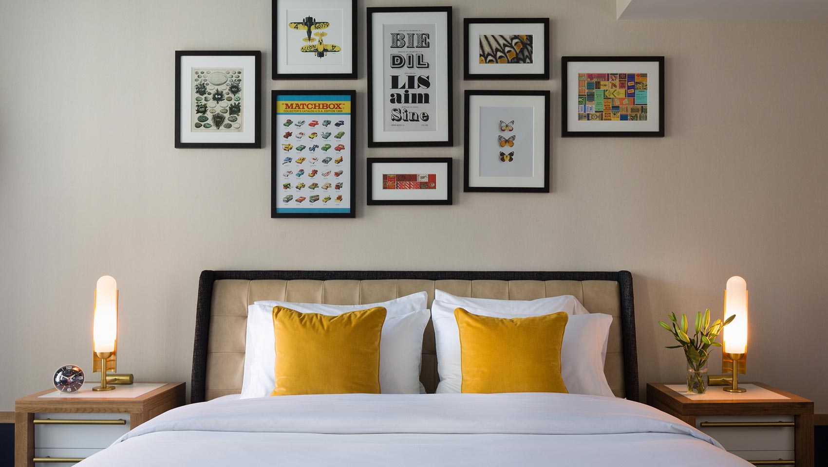 1 King bed detail with nightstands on either side and pictures framed above at the Kimpton Schofield Hotel
